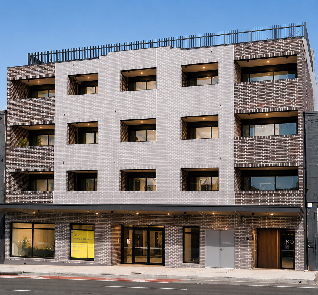 Annandale boarding house street facade — light brick and mixed-use ground floor