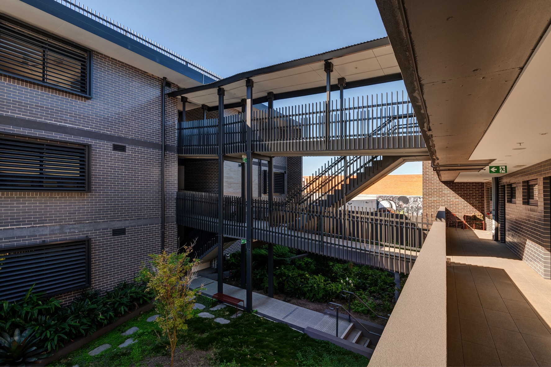 Annandale boarding house open courtyard with steel staircase and landscaping